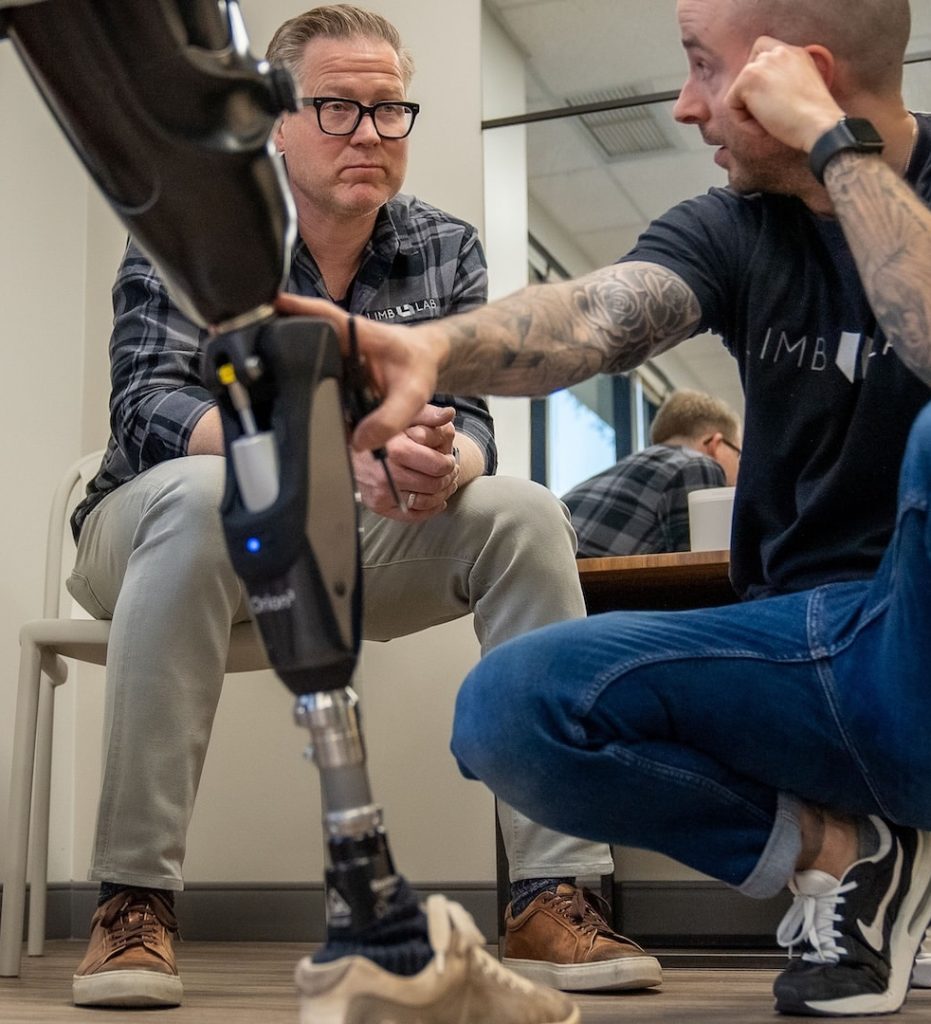 Senior CPOs, Brandon Sampson and Noah Nemgar, working on a prosthetic leg