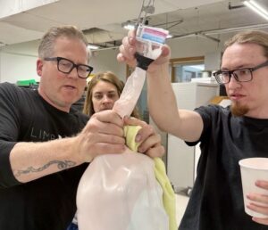 People working on prosthetic leg assembly in a workshop setting